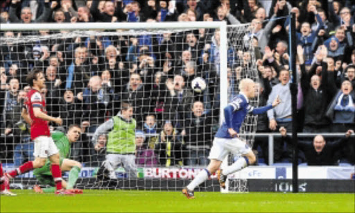 PUNISHED: Steven Naismith, right, of Everton celebrates after scoring the first goal during the English. Premier League match against Arsenal at Goodison Park yesterday. Everton won 3-0 Photo: Alex Livesey/Getty Images