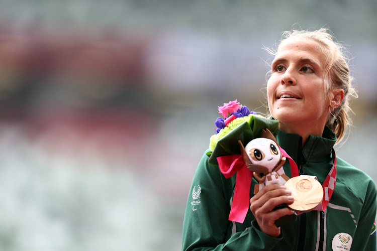 Bronze Medallist Louzanne Coetzee of South Africa celebrates on the podium after winning the women's marathon at the Tokyo 2020 Paralympic Games, in Tokyo, Japan, September 5 2021. Picture: REUTERS/LISI NIESNER