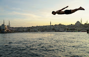 A boy jumps into the sea at Karakoy district in Istanbul, Turkey. 