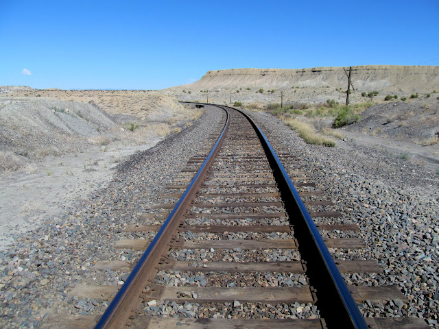 Blue sky reflecting off shiny railroad tracks