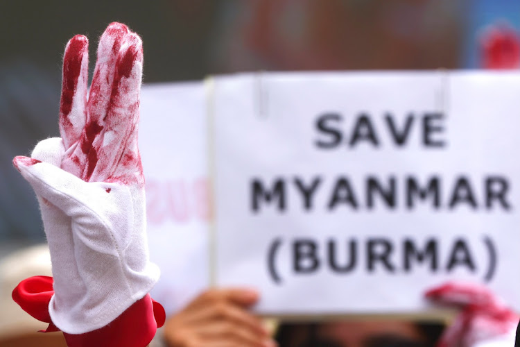 A protester flashes a three-finger salute during a march to protest against Myanmar military coup, in Taipei, Taiwan, May 2, 2021.