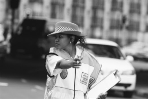 WOMEN IN ACTION: One of the female Johannesburg Metro police officers manning roadblock in Braamfontein, off the M1 highway, yesterday. Pic. Bafana Mahlangu. 02/12/2009./ © Sowetan.20091201 BMA Johannesburg Metro Police Department setup a crime prevention roadblock in Braamfontein off the M1 highway and it was manned by female officers. PHOTO: BAFANA MAHLANGU