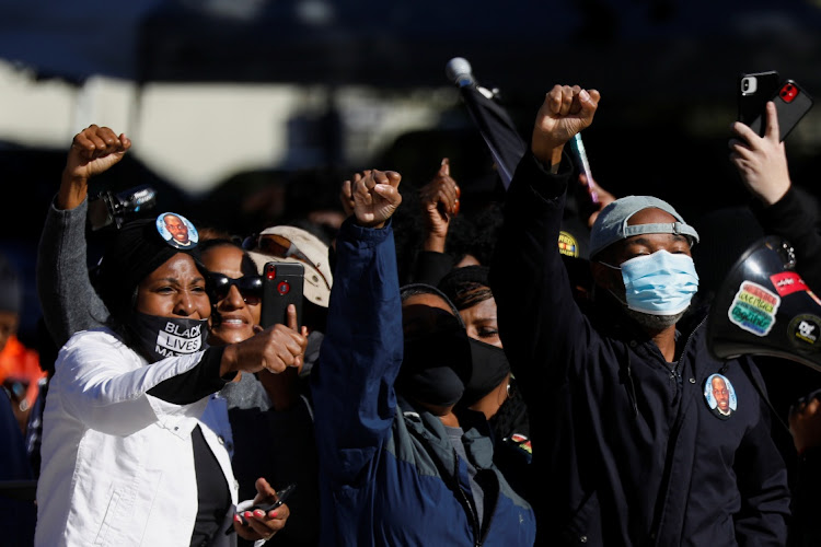 People react outside the Glynn County Courthouse after the jury reached a guilty verdict in the trial of William "Roddie" Bryan, Travis McMichael and Gregory McMichael, charged with the February 2020 death of 25-year-old Ahmaud Arbery, in Brunswick, Georgia, US, November 24, 2021.