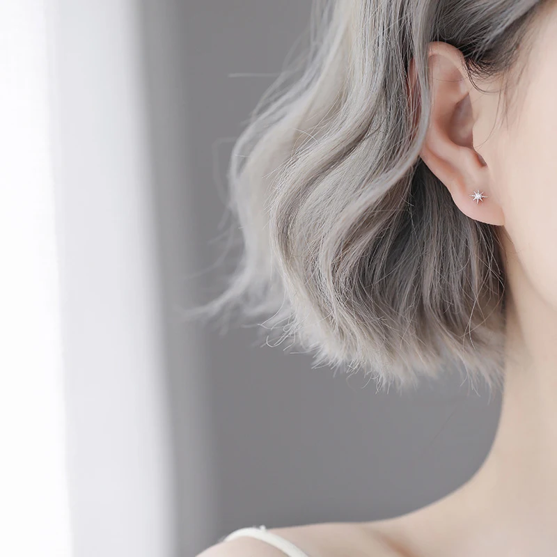 Silver needle rhinestone four eight-pointed stars ear studs. These elegant earrings add sparkle and sophistication to an