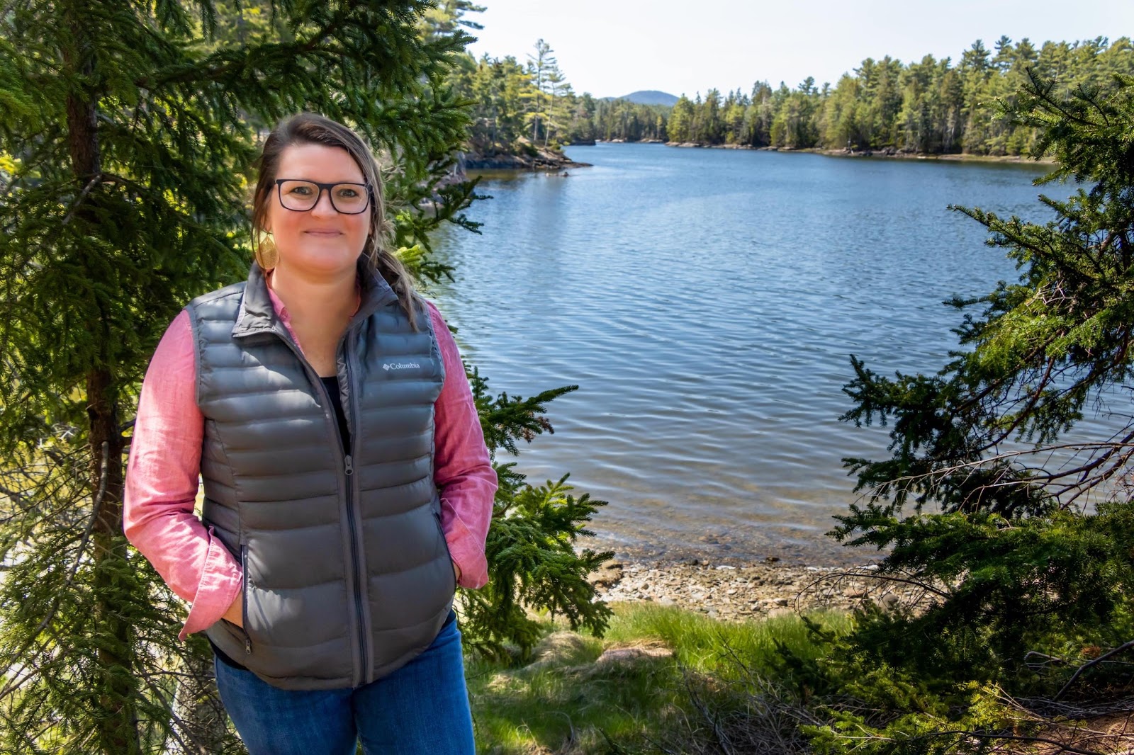 A person standing next to a body of water

Description automatically generated