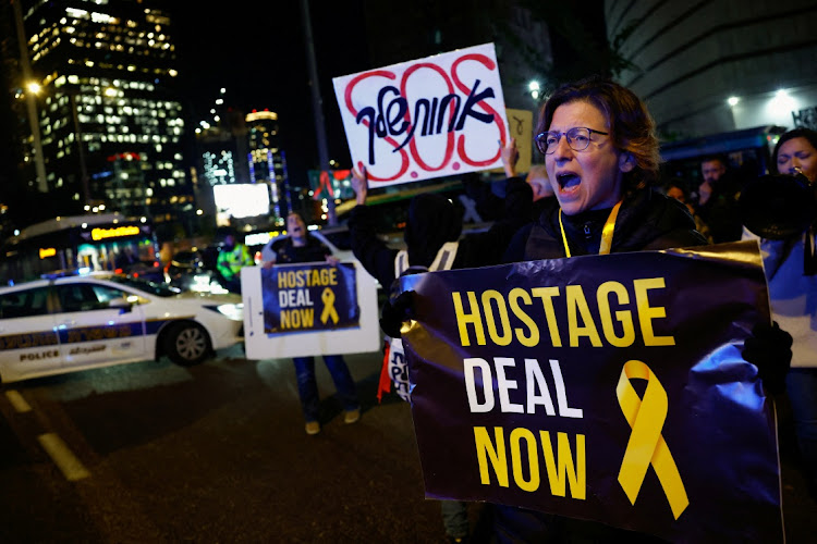 People hold banners as they join a protest demanding a hostage deal amid the ongoing conflict between Israel and Palestinian military group Hamas, in Tel Aviv, Israel, February 4, 2024.