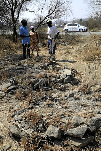 Joseph Mpete, Mapula Matse and Ishmael Dilaoane next to the graves.