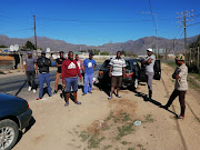 A group of men wash their cars next to the Warmbokkeveld prison in Ceres, where 24 people have tested positive for Covid-19.