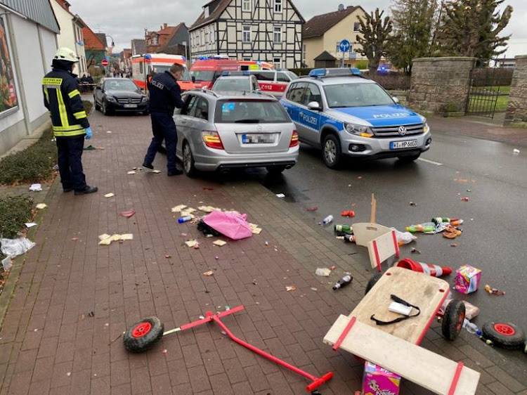 People react at the scene after a car ploughed into a carnival parade injuring several people in Volkmarsen, Germany, on February 24 2020.