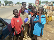 A group of child beggars stand in the streets of Kano.