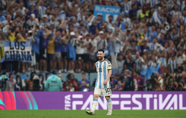 Lionel Messi of Argentina smiles in front of his team's fans at the end Argentina's World Cup semifinal victory aganst Croatia at Lusail Stadium in Lusail City, Qatar on December 13 2022.