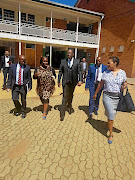 Gauteng education MEC Panyaza Lesufi with his entourage at Three Rivers Secondary School in Vereeniging where a pupil was caught on camera in class throwing an exercise book at her female teacher. /Twitter