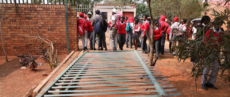 The broken gate at the entrance of TM Letlhake Secondary School in Bekkersdal, west of Johannesburg, where a group of parents have declared a shutdown.