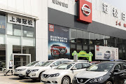 Nissan vehicles stand at a car dealership in Shanghai, China.