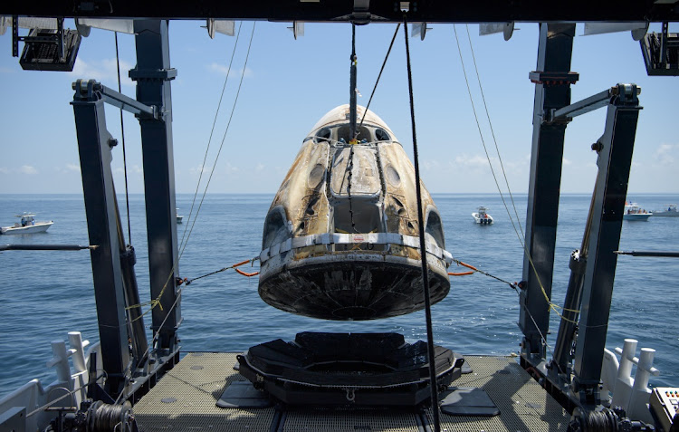 The SpaceX Crew Dragon Endeavour spacecraft is lifted onto the SpaceX GO Navigator recovery ship shortly after it landed with Nasa astronauts Robert Behnken and Douglas Hurley on board in the Gulf of Mexico