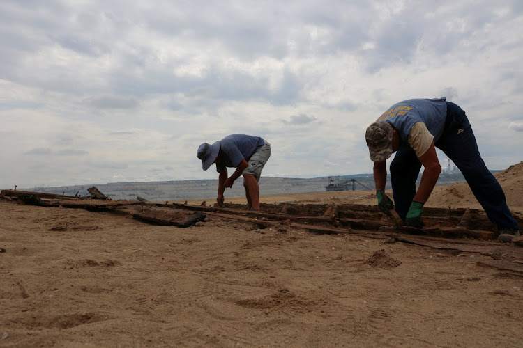 Archaeologists excavate the hull of a wooden ship, an ancient Roman flat-hulled riverine vessel at the ancient city of Viminacium, near Kostolac, Serbia, August 2, 2023.