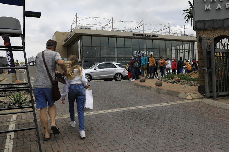 Black Friday shoppers queue at Woodmead Value Mart in Johannesburg on November 26 2021.