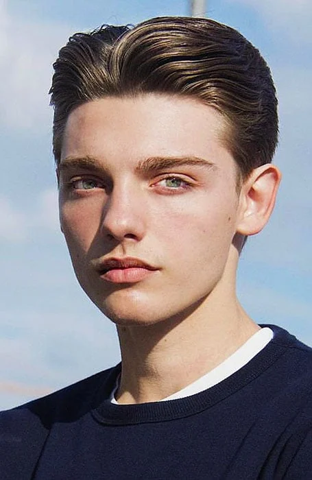 Full picture of a guy rocking the coiffure with a combed back look