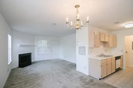 Dining room with light carpet and view of living room and kitchen