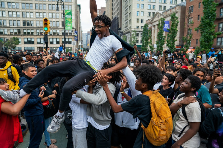 People carry a person after popular live streamer Kai Cenat announced a "giveaway" event that grew chaotic, prompting police officers to respond and disperse the crowd at Union Square and the surrounding streets, in New York City, US August 4, 2023.