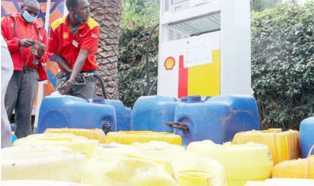 An attendant at a Shell petrol station in Westlands, Nairobi, fills a jerican with kerosene yesterday.