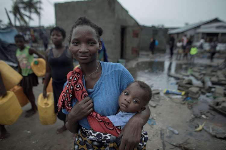 People return to the Praia Nova Village neighbourhood in Beira, Mozambique, on March 17 2019 following Cyclone Idai.