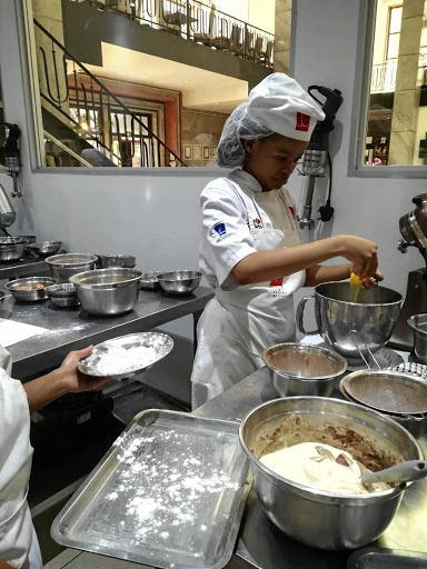 A student prepares her mixtures to bake.