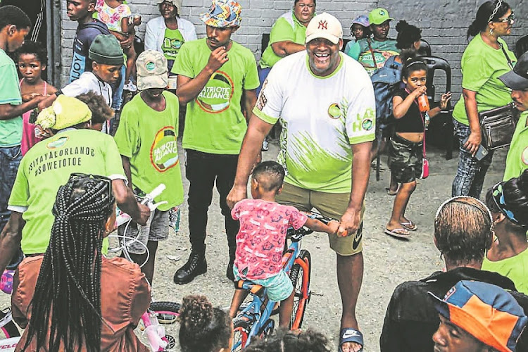 Let’s cycle back: PA leader Gayton McKenzie hands out bikes in Borcherds, George. Picture: Facebook/Gayton McKenzie