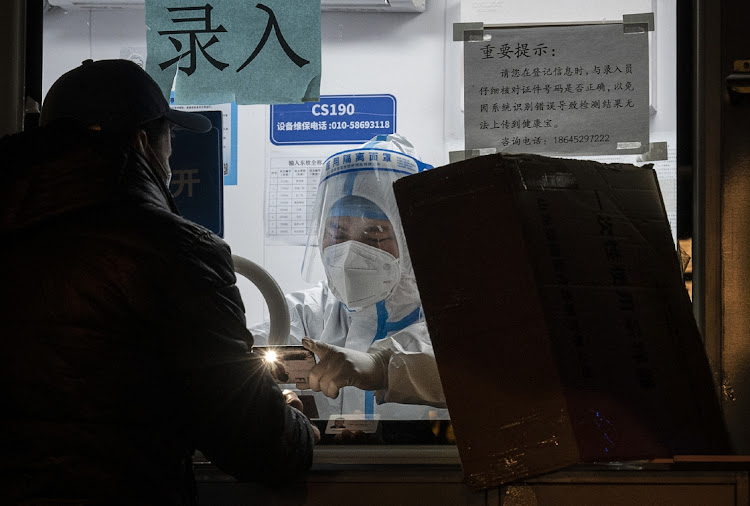 An epidemic control worker registers a man for a Covid-19 test in Beijing, China, November 7 2022. Picture: KEVIN FRAYER/GETTY IMAGES