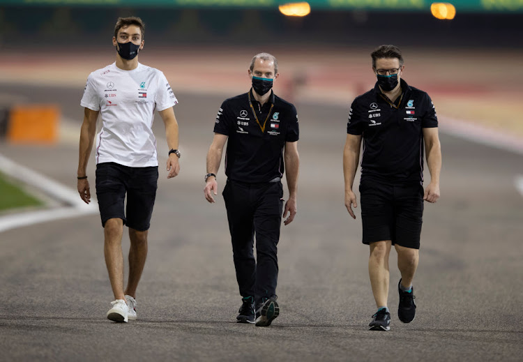 F1 driver George Russell of Great Britain inspects the track with Mercedes engineers ahead of the F1 Grand Prix of Sakhir at Bahrain International Circuit on December 02, 2020 in Bahrain, Bahrain. Russell is due to replace Lewis Hamilton after he tested positive for Covid-19.