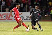 Orlando Pirates left back Innocent Maela (R) challenges Sinethemba Jantje (L) of Free State Stars during an Absa Premiership match at Goble Park in Bethlehem. Pirates won 3-1.  