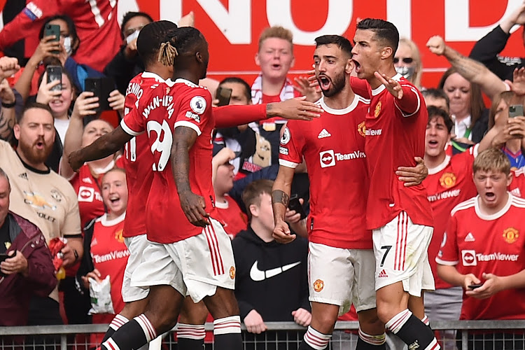 United's Portuguese striker Cristiano Ronaldo (R) celebrates with teammates after scoring the opening goal of the English Premier League football match against Newcastle at Old Trafford in Manchester
