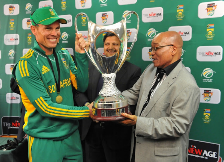 Former President Jacob Zuma (R) presents the Trophy to former Proteas player Johan Botha as one of the Gupta brothers (C) looks on. File photo