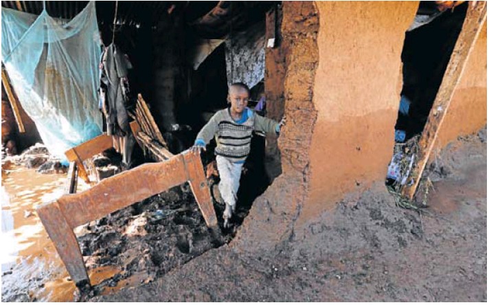 A child in a house damaged by flooding after the dam burst in Solai