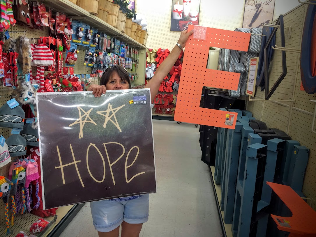 Terri and I shopping for decorations for Emma's grad party...turned into more of an off to college party...She is going to Hope College in Holland, MI...thus the reason for the sign and the orange letters.