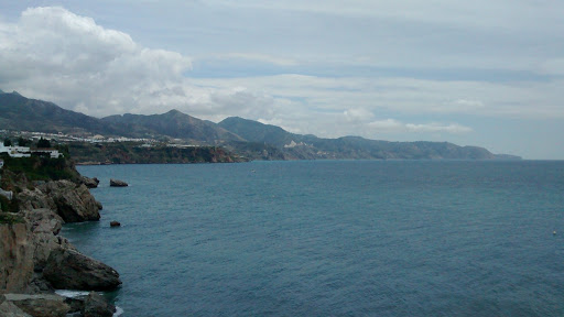 a large body of water with mountains in the background