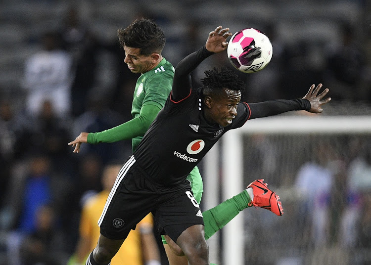 Mohammed El Fakih of Al Ahli Tripoli challenges Siphesihle Ndlovu of Orlando Pirates in the Caf Confederation Cup semifinal second leg match at Orlando Stadium on the May 15 2022.