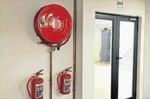 SOUND THE ALARM: An example of a fire reel and extinguisher set up which has been serviced by legitimate servicers Picture: ALAN EASON