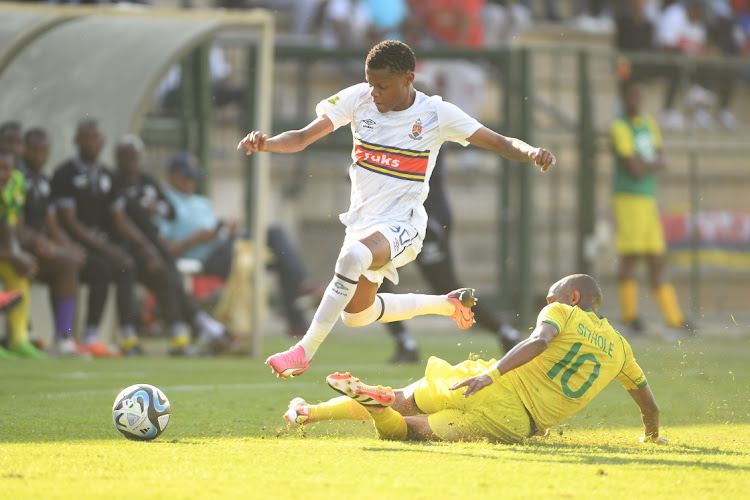 Malekgene Mamphuru of University of Pretoria FC skips over the challenge of Baroka FC's Sekela Sithole in the Motsepe Foundation League match at Tuks Stadium in Pretoria on Sunday.