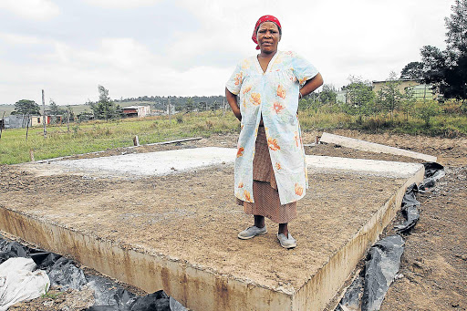 NEEDING A HOME: Ntombekhaya Bolmani of Msintsi Village in Mdantsane stands on the foundation of her RDP house, which is still uncompleted since last year Picture: SIBONGILE NGALWA