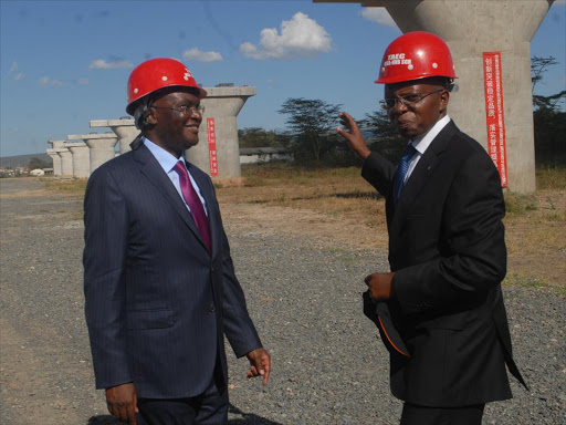 Transport CS James Macharia with Kenya Railways Corparation MD Atanas Maina at the Standard Gauge Railway Athi River Super Grand Bridge after addressing journalists touring the project, Athi River, Makueni County on Thursday. Along the project the state plans to build an Inland Container Terminal at Nairobi, Special Economic Zone in Naivasha and a Port at Kisumu/FILE