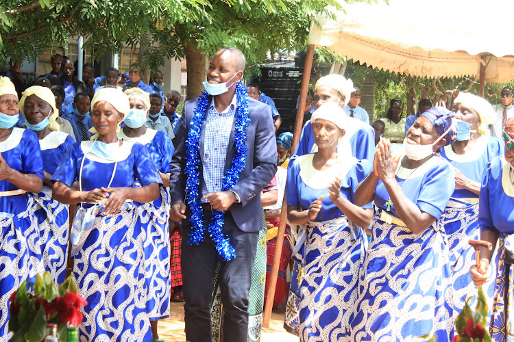 Mwingi West MP Charles Nguna dances with Kakululo Secondary School parents on Friday, February 19