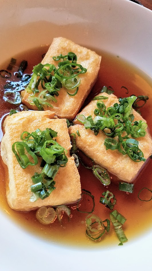 Shigezo Agedashi Tofu appetizer with fried tofu, mochi, ginger, grated daikon, shishito pepper