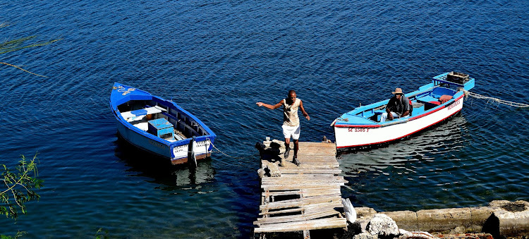 Fishermen in Cayo Granma, a little fantasy island of red-roofed wooden houses on the coast of Cuba. 