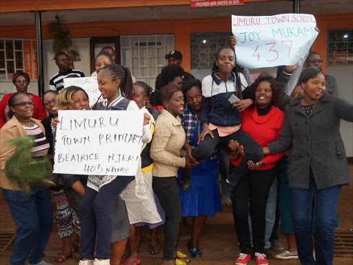 Parents and teachers of Limuru Town Primary School cerebrate good earned by this years KCPE candidates Joy Mukami with 437, Michael Karani with 427, Christine Nungari 425 among others at their school yesterday.