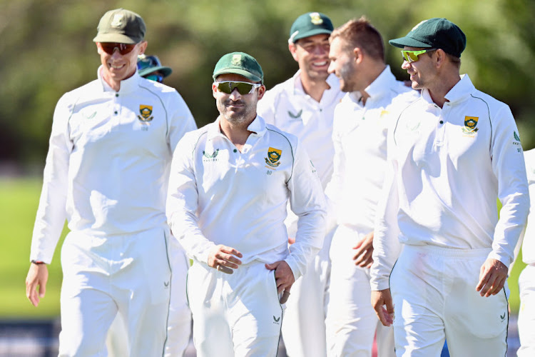 Captain Dean Elgar of South Africa (C) reacts after Aiden Markram of South Africa dismisses Kyle Jamieson of New Zealand during day two of the First Test Match in the series between New Zealand and South Africa at Hagley Oval on February 18, 2022 in Christchurch, New Zealand.