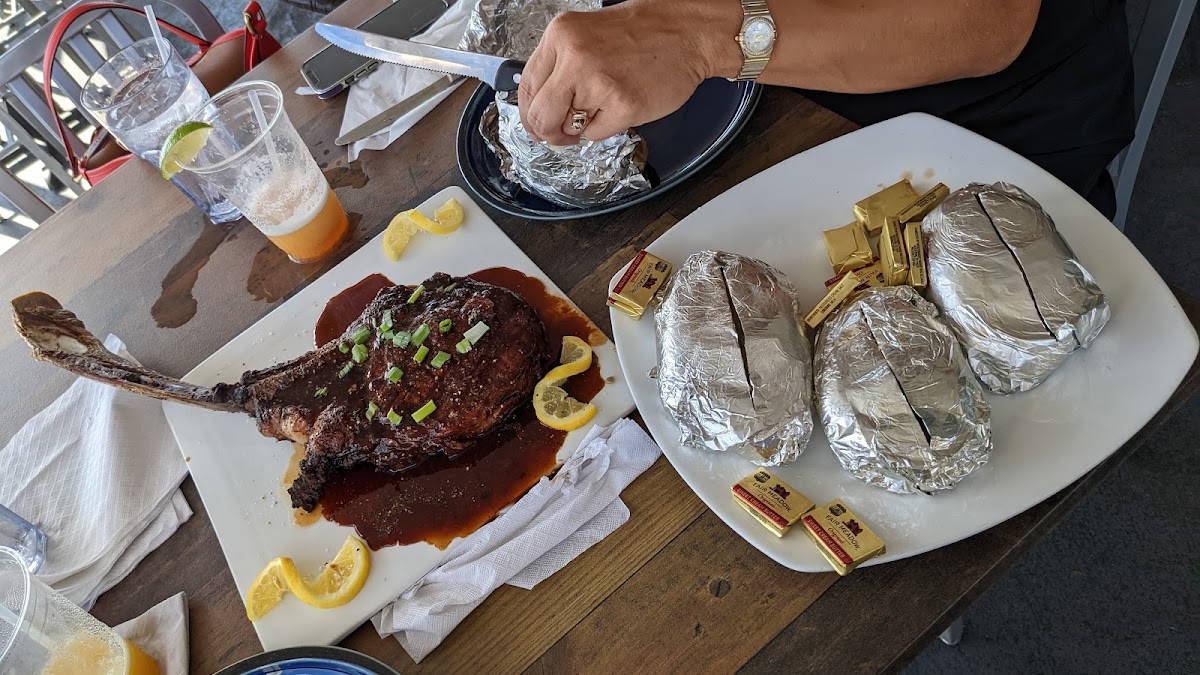 Tomahawks Steak with baked potatos (we asked for extra potato in place of the not safe mac n cheese and roll)