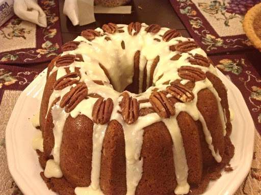 Orange Sweet Potato Pound Cake With Orange Butter Glaze, & topped with Pecan Halves.
