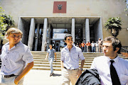 OUT ON A WARNING: Charl Blom and Cobus Muller leave the Bloemfontein Magistrate's Court with their lawyer, Rudolf de Beer. They appeared in connection with an allegedly racist attack at The University of the Free State.