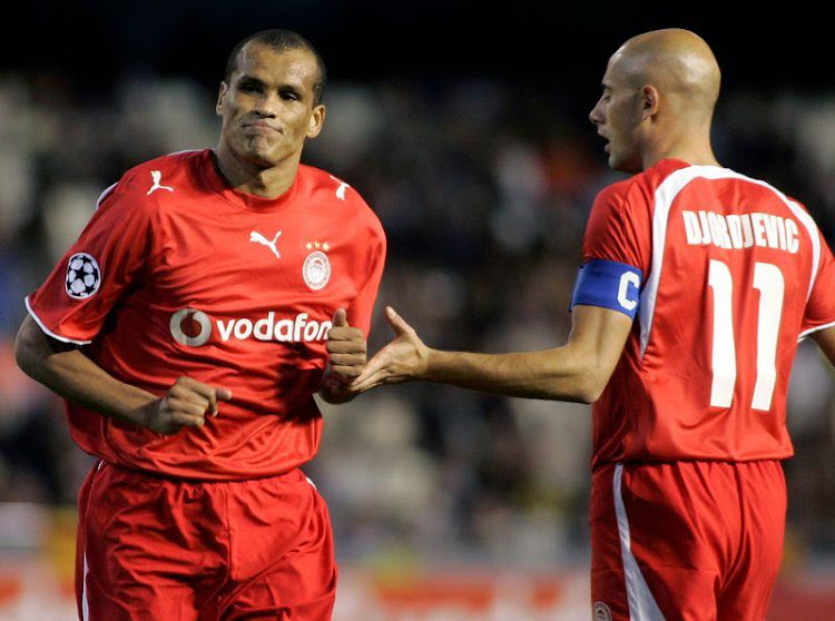 Olympiakos' Rivaldo (L) and Predrag Djordjevic in action during a Champions League Group D match against Valencia at the Mestalla stadium in Valencia November 22, 2006